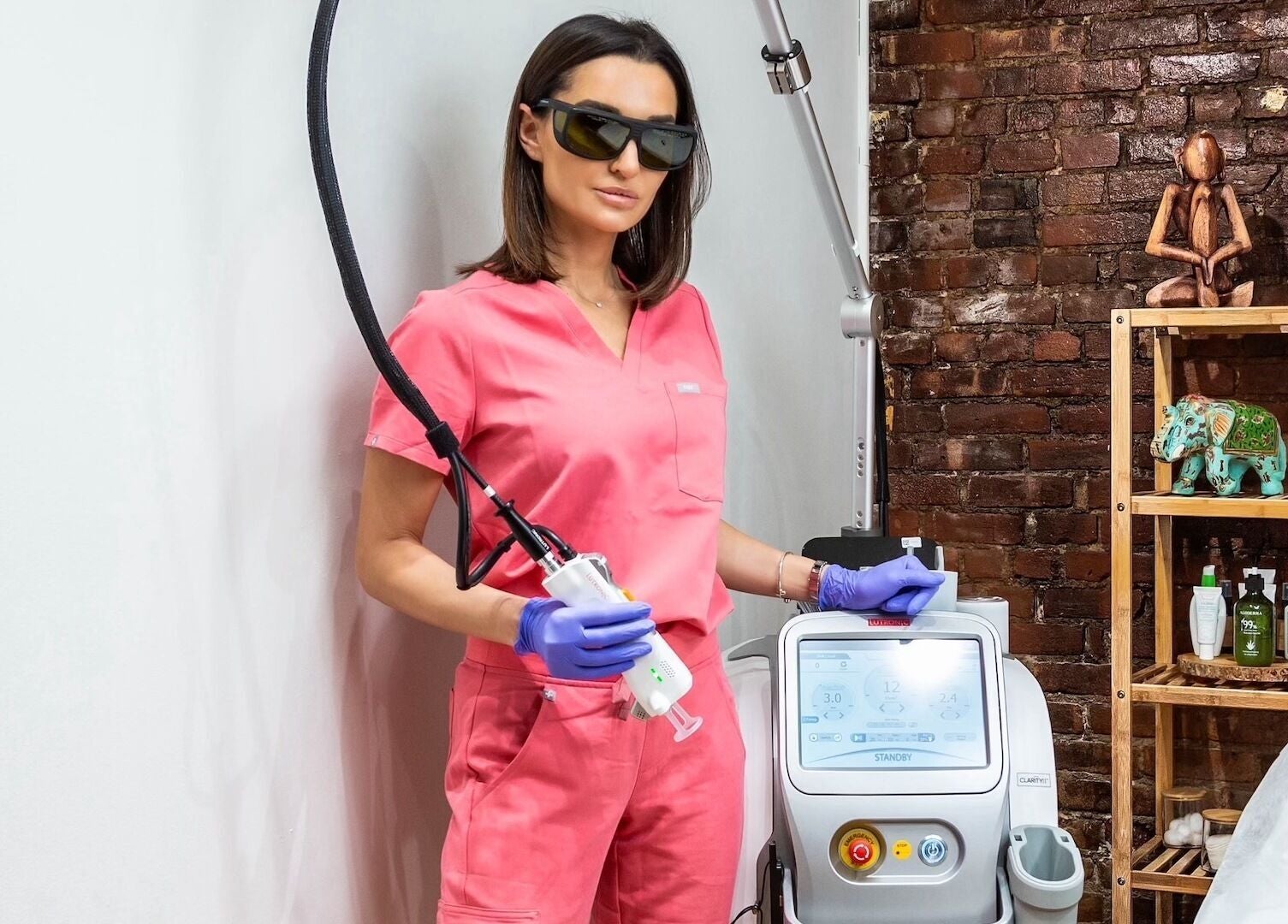 Laser technician at Écou's Laser Boutique in Scottsdale, Arizona, US, operating advanced equipment.