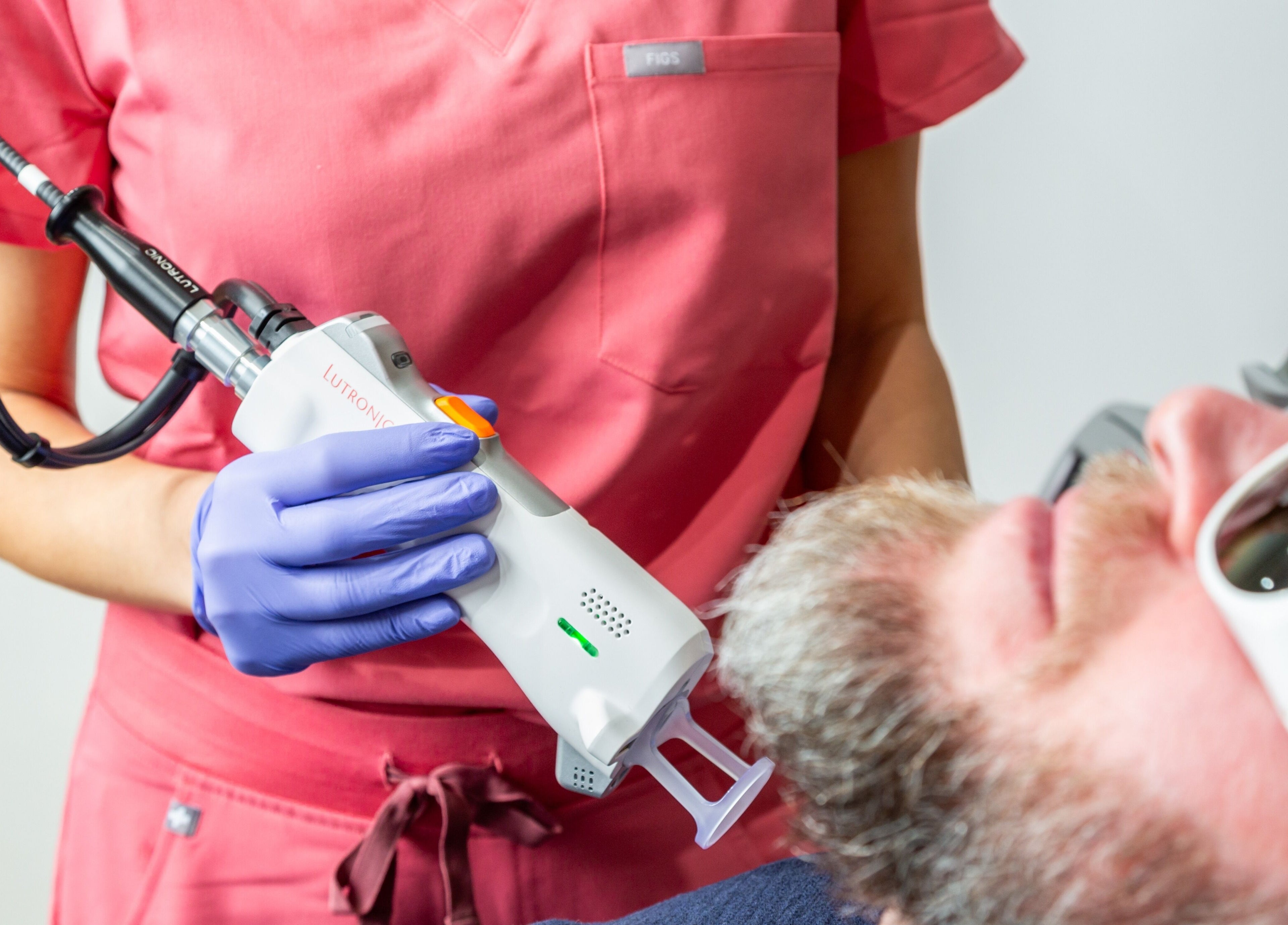 Laser treatment at Écou's Laser Boutique in Scottsdale, Arizona, US. Technician applying a laser to client's face.