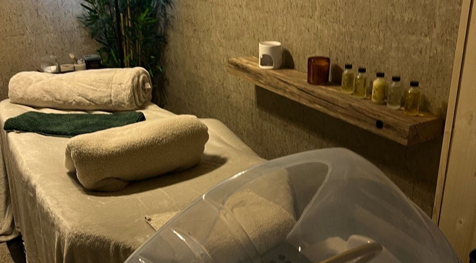 Relaxing therapy room at The Serenity Rooms, Emsworth, England, GB with massage table and oils.