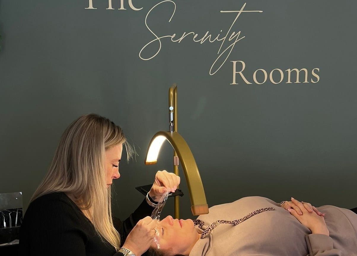 Therapist performing beauty treatment at The Serenity Rooms, Emsworth, England, GB under soft lighting.