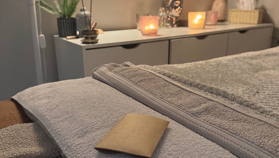 Relaxing spa setup at Balanced Within By Jade in Bristol, England, GB, featuring candles and soft towels.
