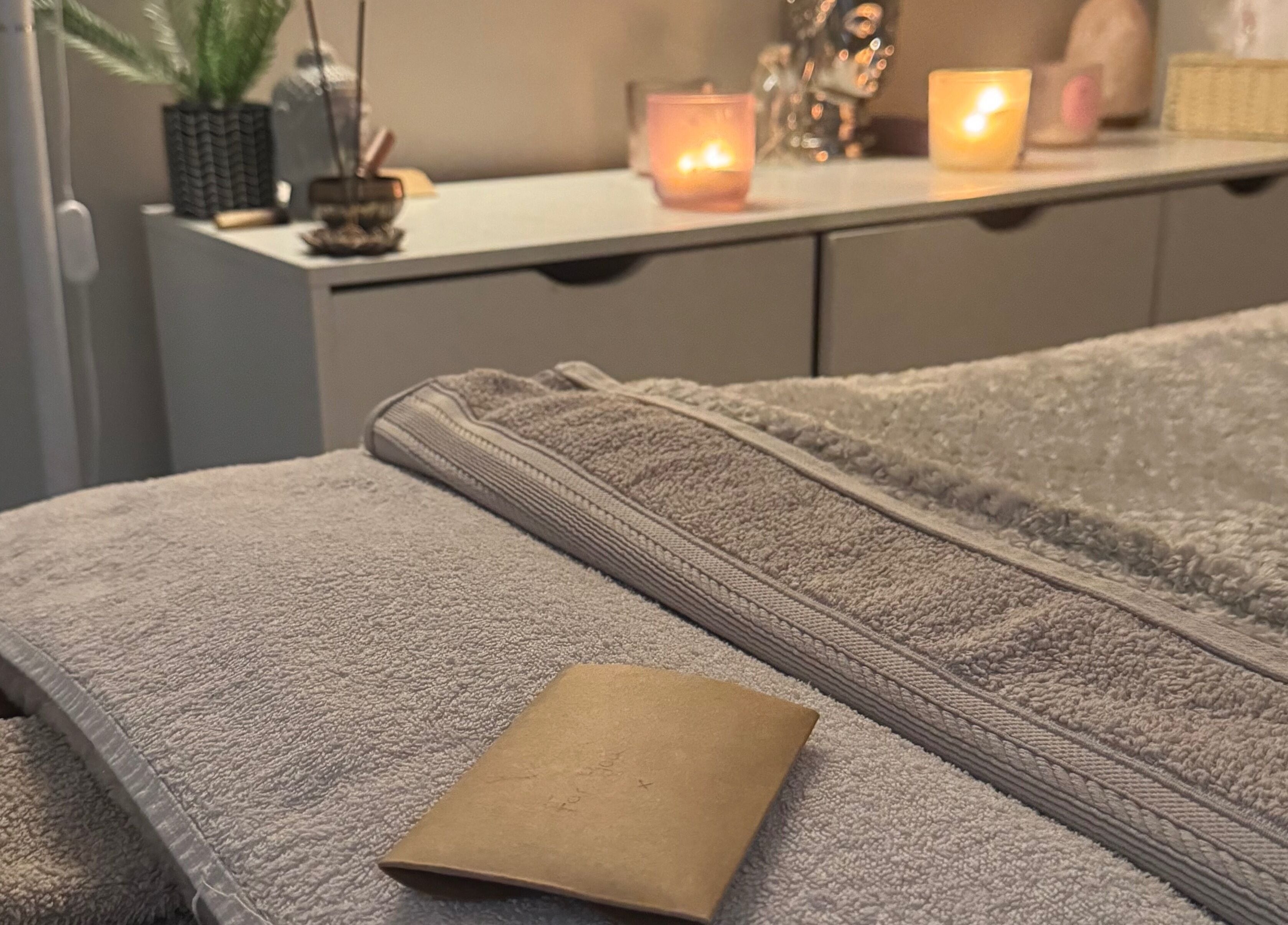 Relaxing spa setup at Balanced Within By Jade in Bristol, England, GB, featuring candles and soft towels.