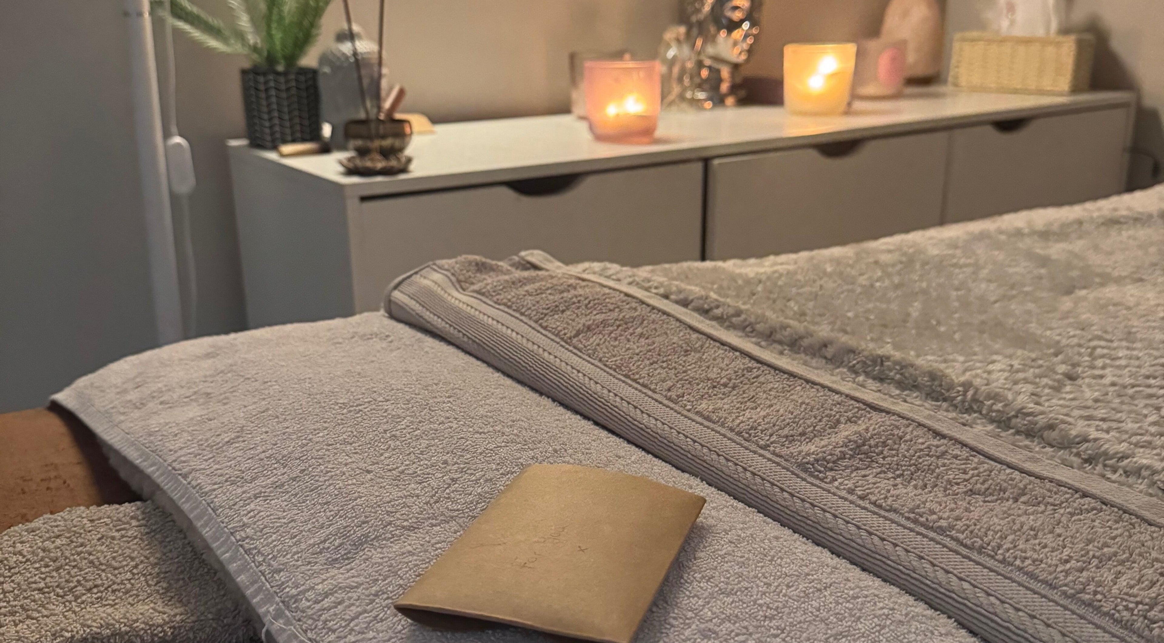 Relaxing spa setup at Balanced Within By Jade in Bristol, England, GB, featuring candles and soft towels.