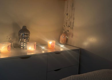Candles and Buddha statue creating a calming ambiance at Balanced Within By Jade, Bristol, England, GB.