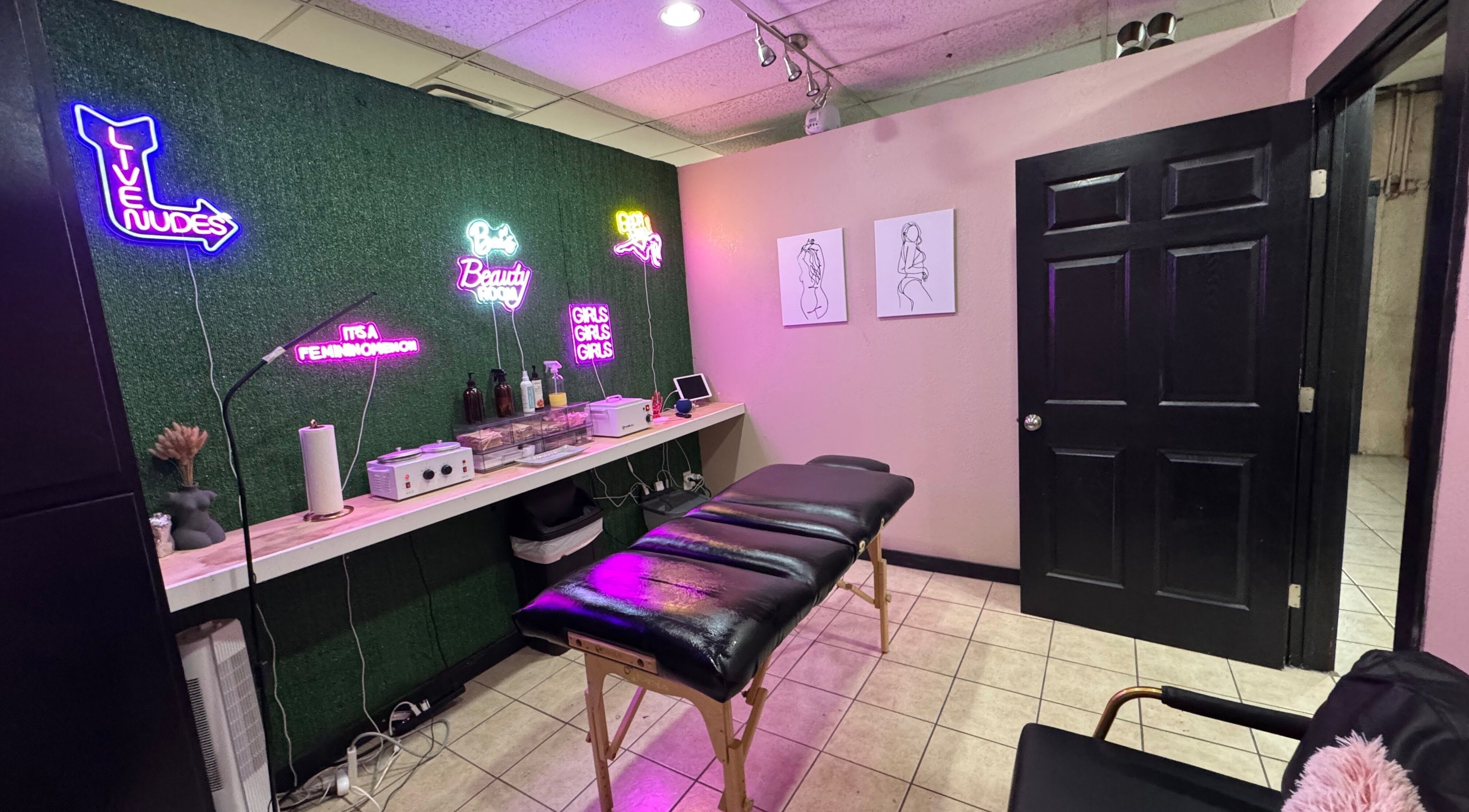Chic treatment room at Bai’s Beauty Room - Krum Clips Salon, Krum, Texas, featuring vibrant neon signs.