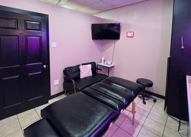 Cozy treatment room at Bai’s Beauty Room - Krum Clips Salon, Krum, Texas, US featuring a massage bed.