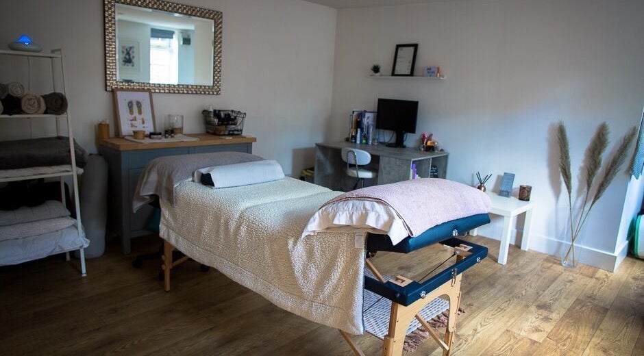 Calm therapy room at Lisa Russell Mind and Body in Loughton, England, GB, featuring a massage table and decor.