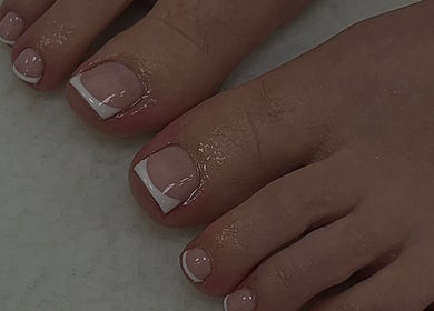 Elegant French pedicure at Ormofia, Sunderland, England, GB. Perfectly styled toes with glossy finish.