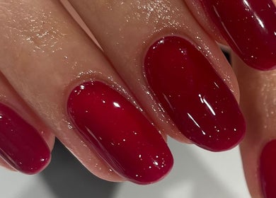 Vibrant red manicure at Divine Beauty & Aesthetics in Lichfield, England, GB.