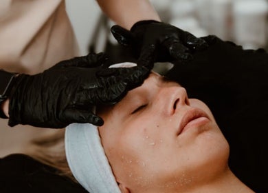 Relaxing facial treatment at Divine Beauty & Aesthetics in Lichfield, England, GB. Woman receiving professional care.