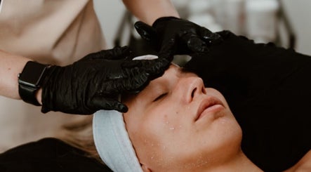 Relaxing facial treatment at Divine Beauty & Aesthetics in Lichfield, England, GB. Woman receiving professional care.