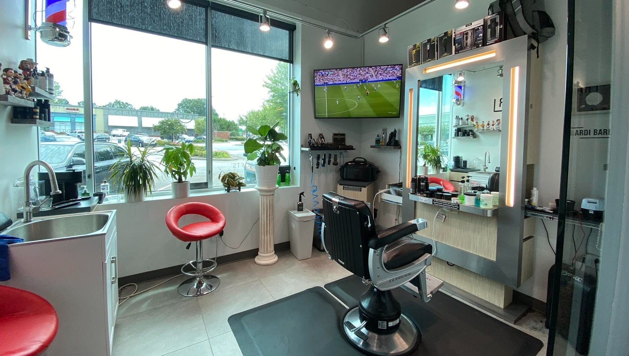 Modern interior of Hardi Barbershop in Roswell, Georgia, US featuring sleek chairs and a bright atmosphere.