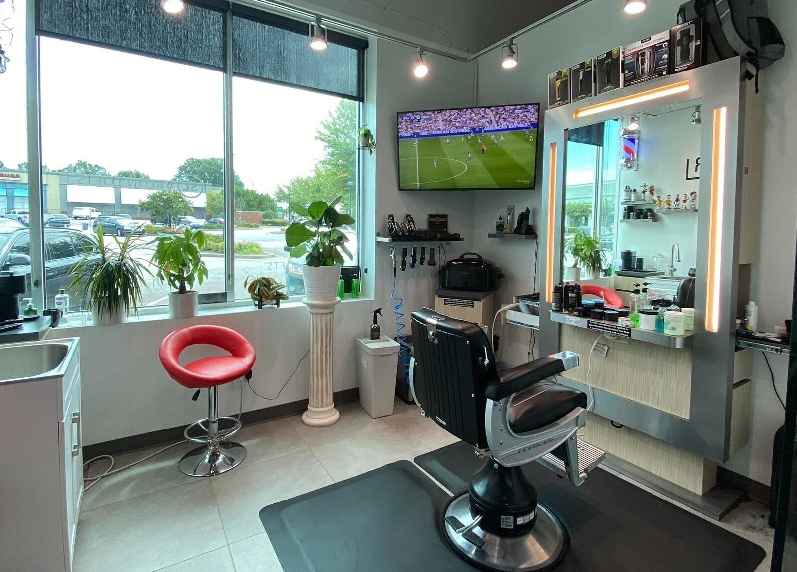 Modern interior of Hardi Barbershop in Roswell, Georgia, US featuring sleek chairs and a bright atmosphere.