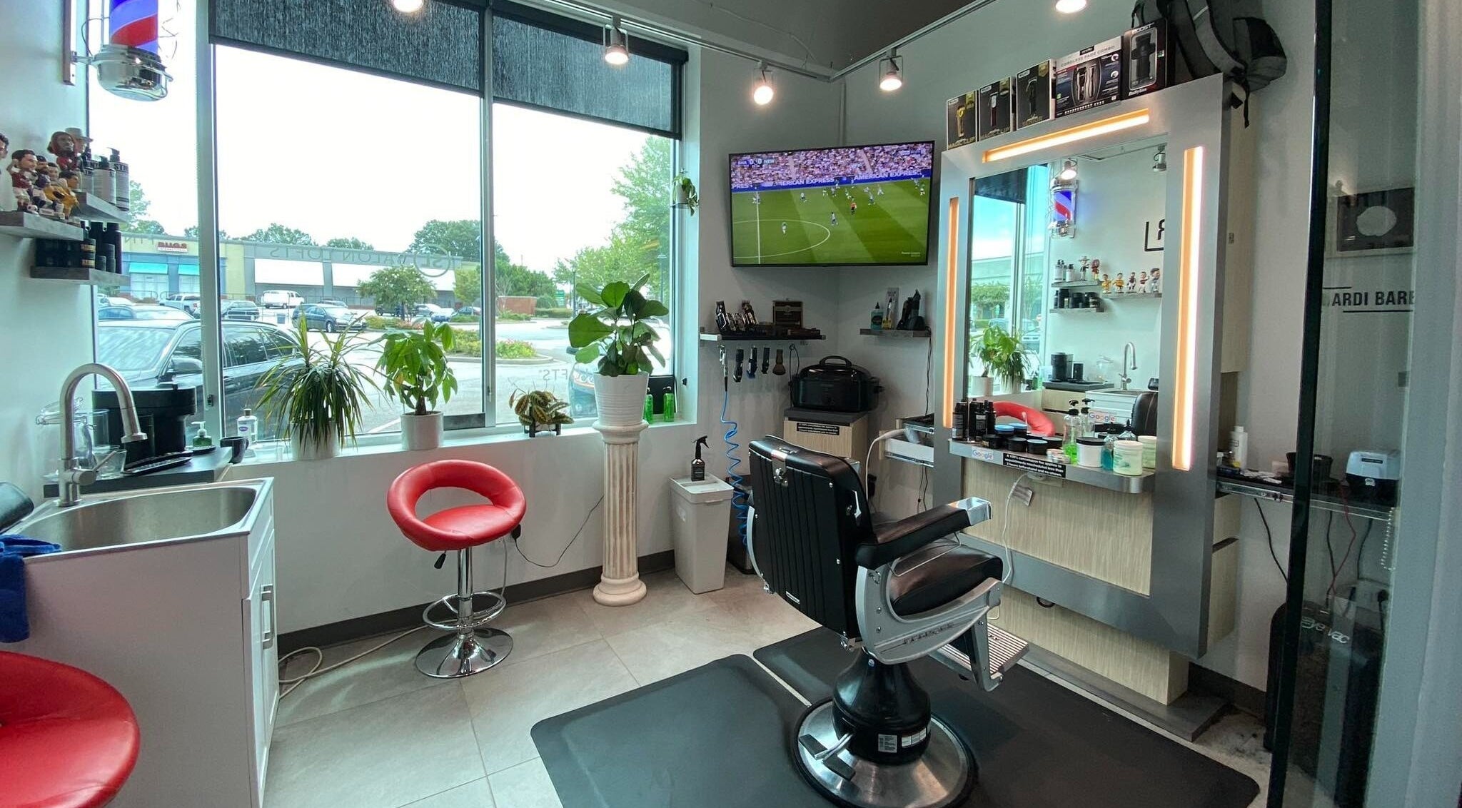 Modern interior of Hardi Barbershop in Roswell, Georgia, US featuring sleek chairs and a bright atmosphere.