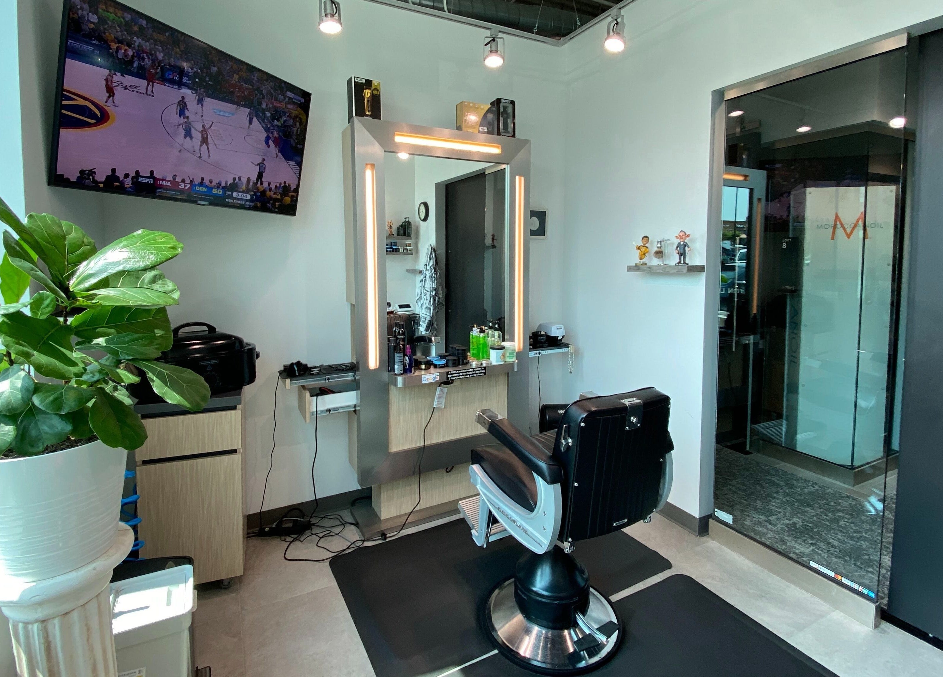 Hardi Barbershop interior with stylish chair and plant in Roswell, Georgia, US.