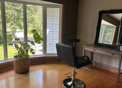 Bright and stylish salon corner at SEW Hair Extensions in Alberta, Alberta, CA with chair, mirror, and plants.