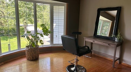 Bright and stylish salon corner at SEW Hair Extensions in Alberta, Alberta, CA with chair, mirror, and plants.