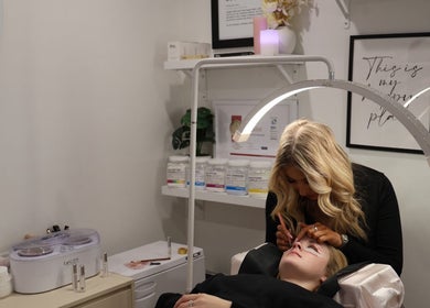 Beautician applying eyelash extensions at Beauty at Caitlyn's, Harrington Park, New South Wales, AU.