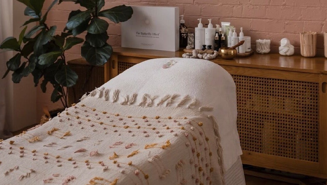 Relaxing treatment room at Salt Aesthetics, Hobart, Tasmania, AU, featuring cozy decor and wellness products.