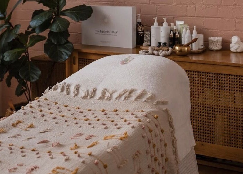Relaxing treatment room at Salt Aesthetics, Hobart, Tasmania, AU, featuring cozy decor and wellness products.