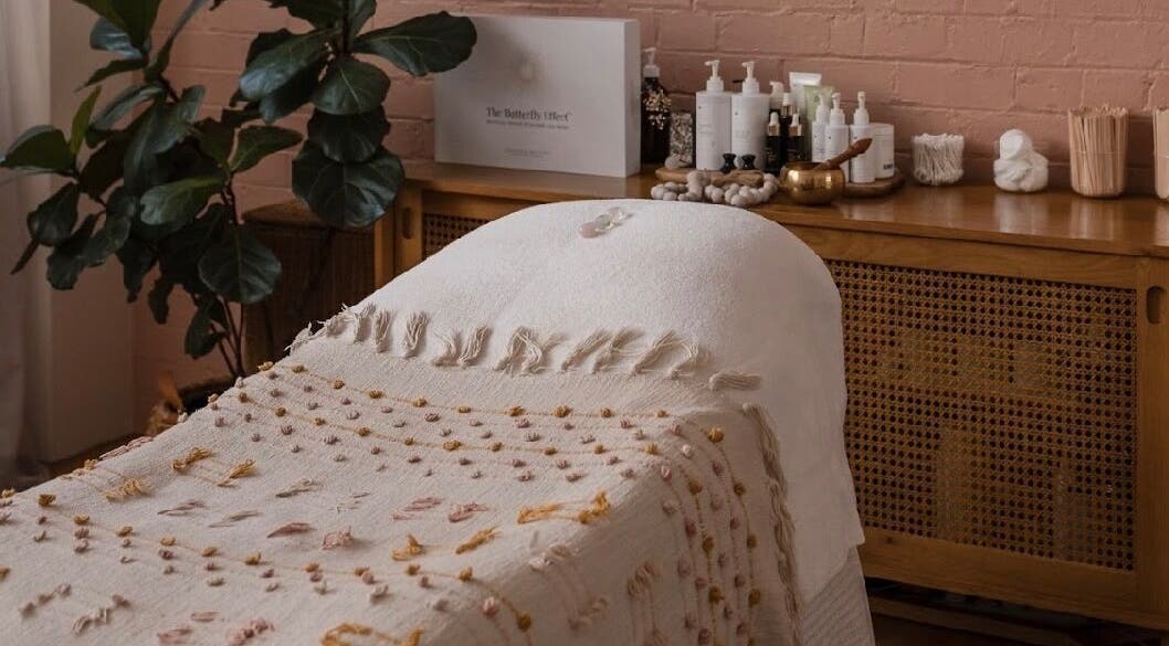Relaxing treatment room at Salt Aesthetics, Hobart, Tasmania, AU, featuring cozy decor and wellness products.