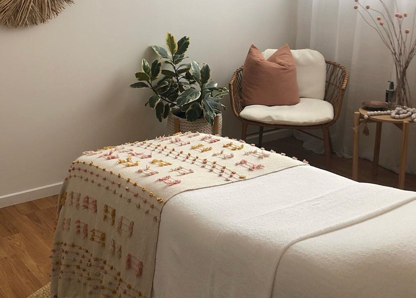 Relaxing treatment room at Salt Aesthetics, Hobart, Tasmania, AU, with soft decor and comfortable seating.
