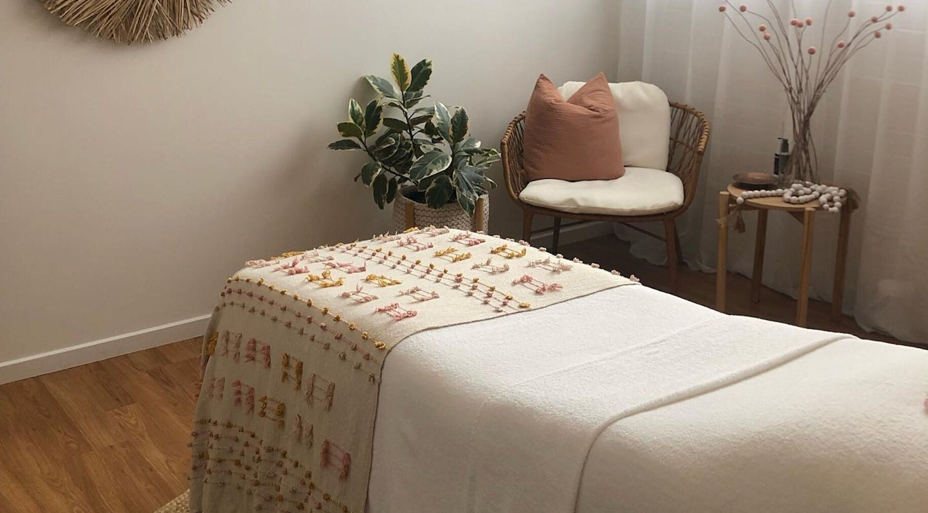 Relaxing treatment room at Salt Aesthetics, Hobart, Tasmania, AU, with soft decor and comfortable seating.