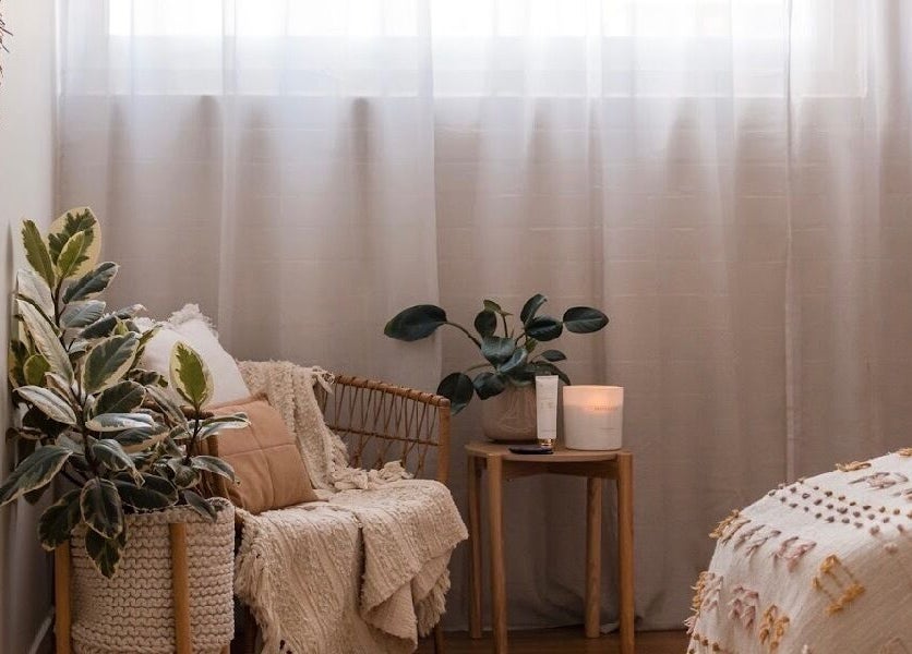 Relaxing spa room at Salt Aesthetics in Hobart, Tasmania, AU with cozy seating, plants, and soft lighting.