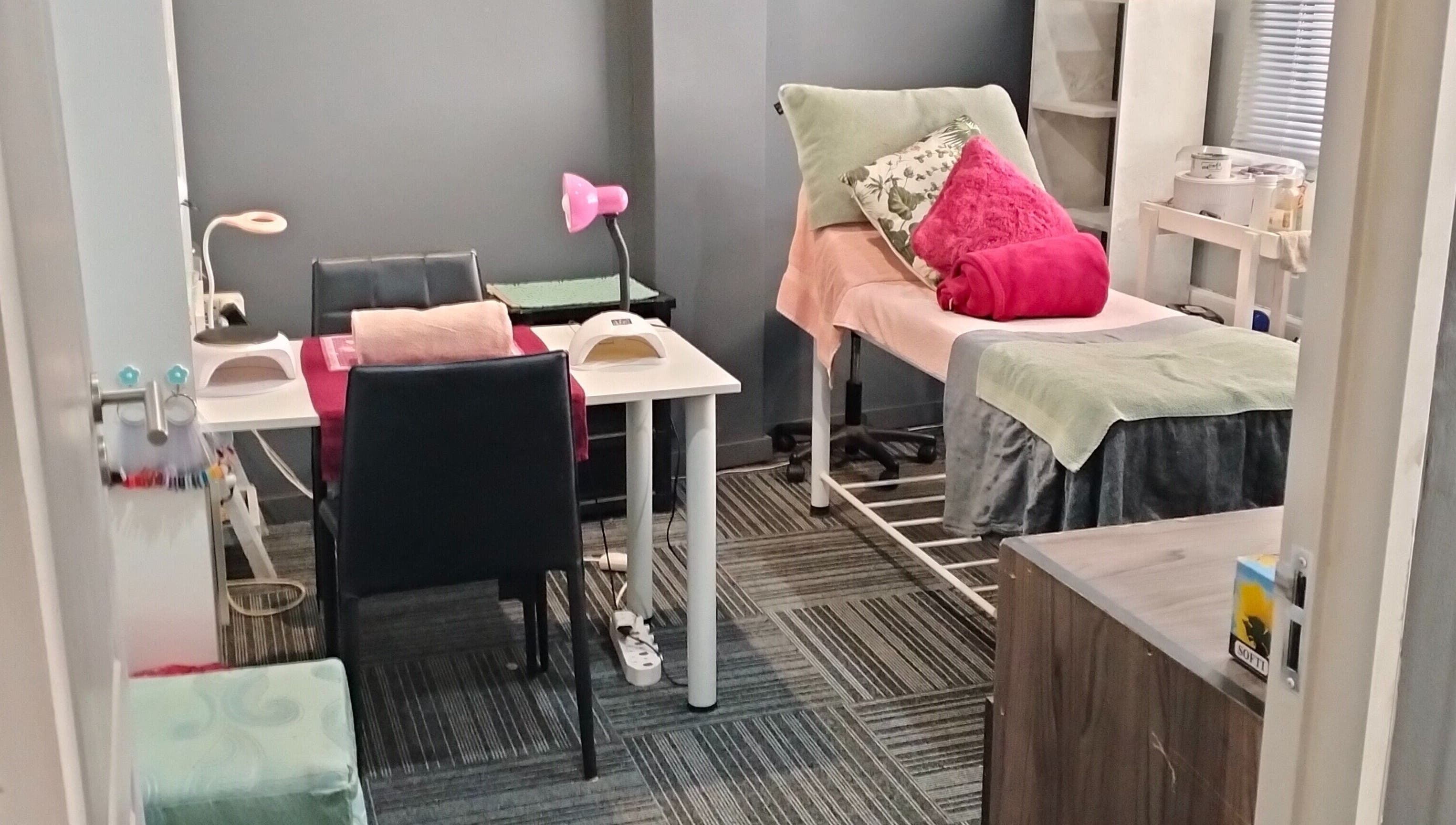 Tranquil treatment room at YDP Beauty & Nails in Potchefstroom, North West, ZA, featuring a massage table and nail station.