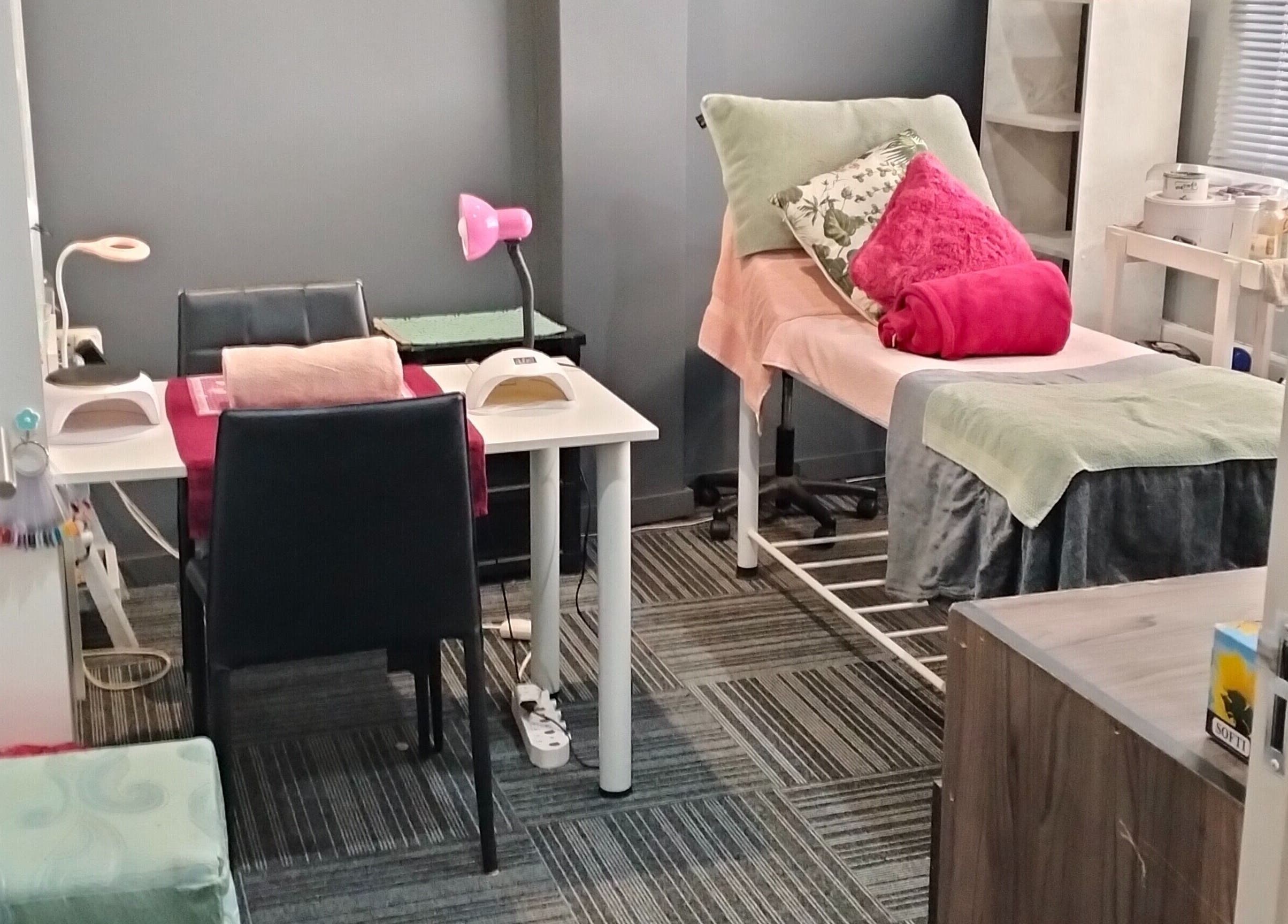 Tranquil treatment room at YDP Beauty & Nails in Potchefstroom, North West, ZA, featuring a massage table and nail station.