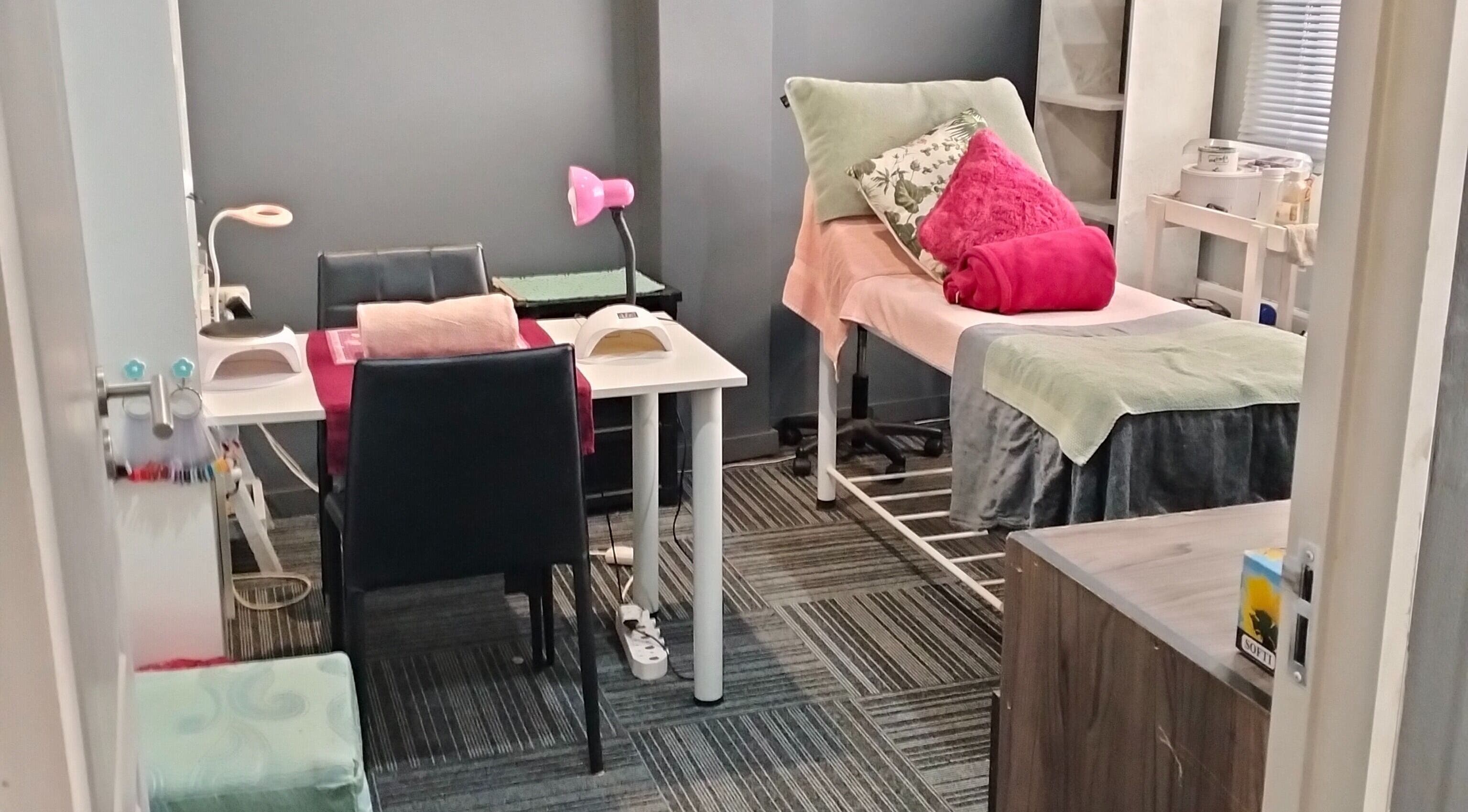 Tranquil treatment room at YDP Beauty & Nails in Potchefstroom, North West, ZA, featuring a massage table and nail station.