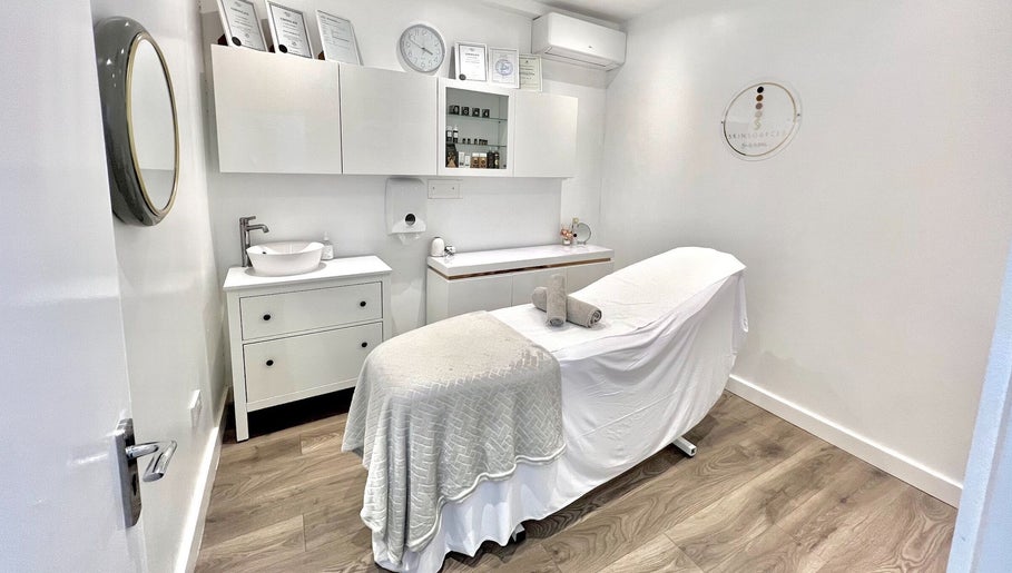 Cozy treatment room at N1 Beauty Base in London, England, GB, featuring a neutral palette and a therapy bed.
