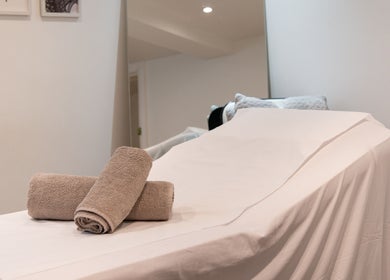 Relaxing spa bed with towels at N1 Beauty Base, London, England, GB, inviting a serene wellness experience.