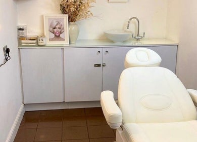 Serene treatment room at N1 Beauty Base, London, England, GB, featuring an elegant white chair and decor.