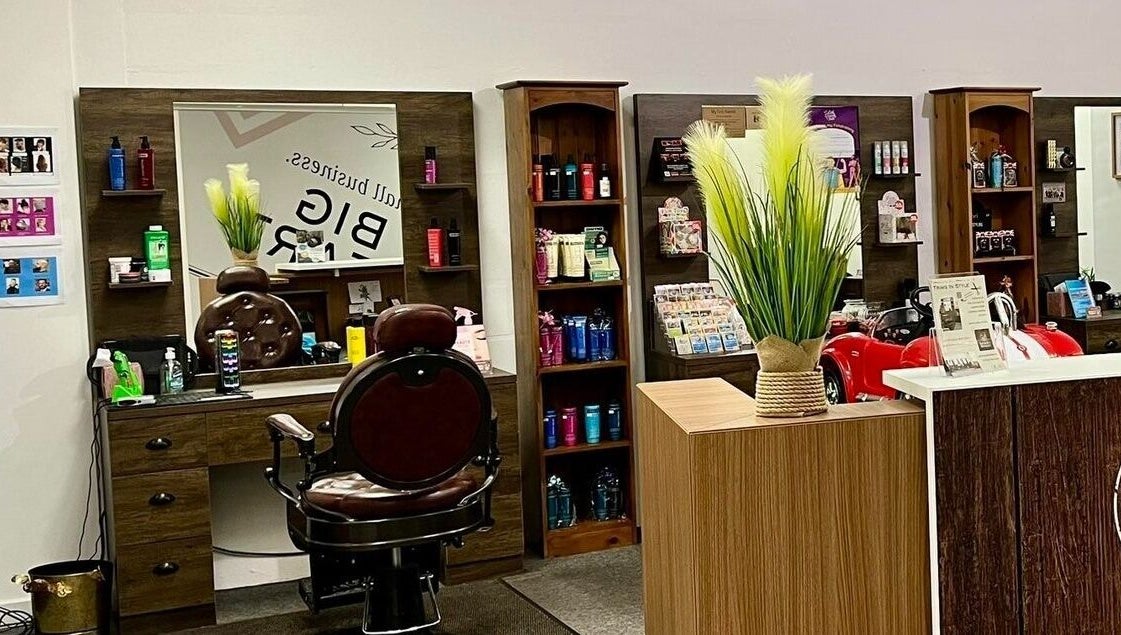 Chic interior of Darwin's Barbers in Shrewsbury, England, GB showcasing barber chair and grooming products.