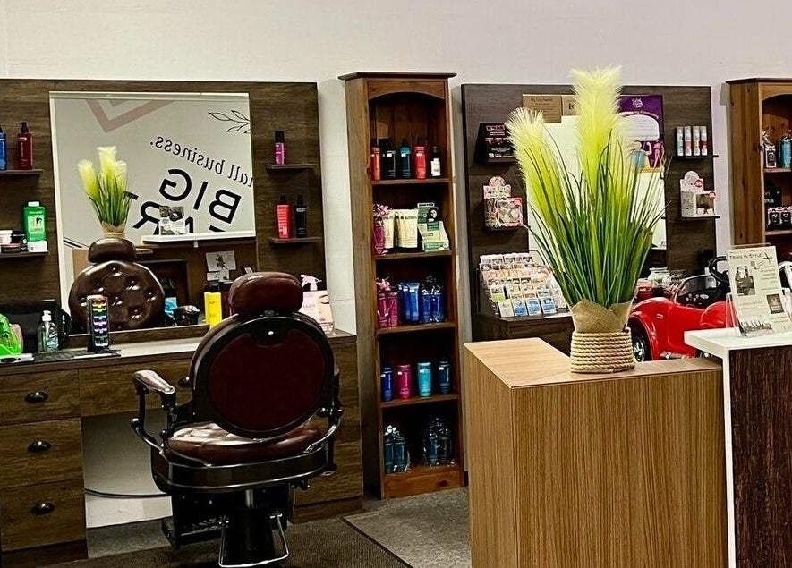 Chic interior of Darwin's Barbers in Shrewsbury, England, GB showcasing barber chair and grooming products.