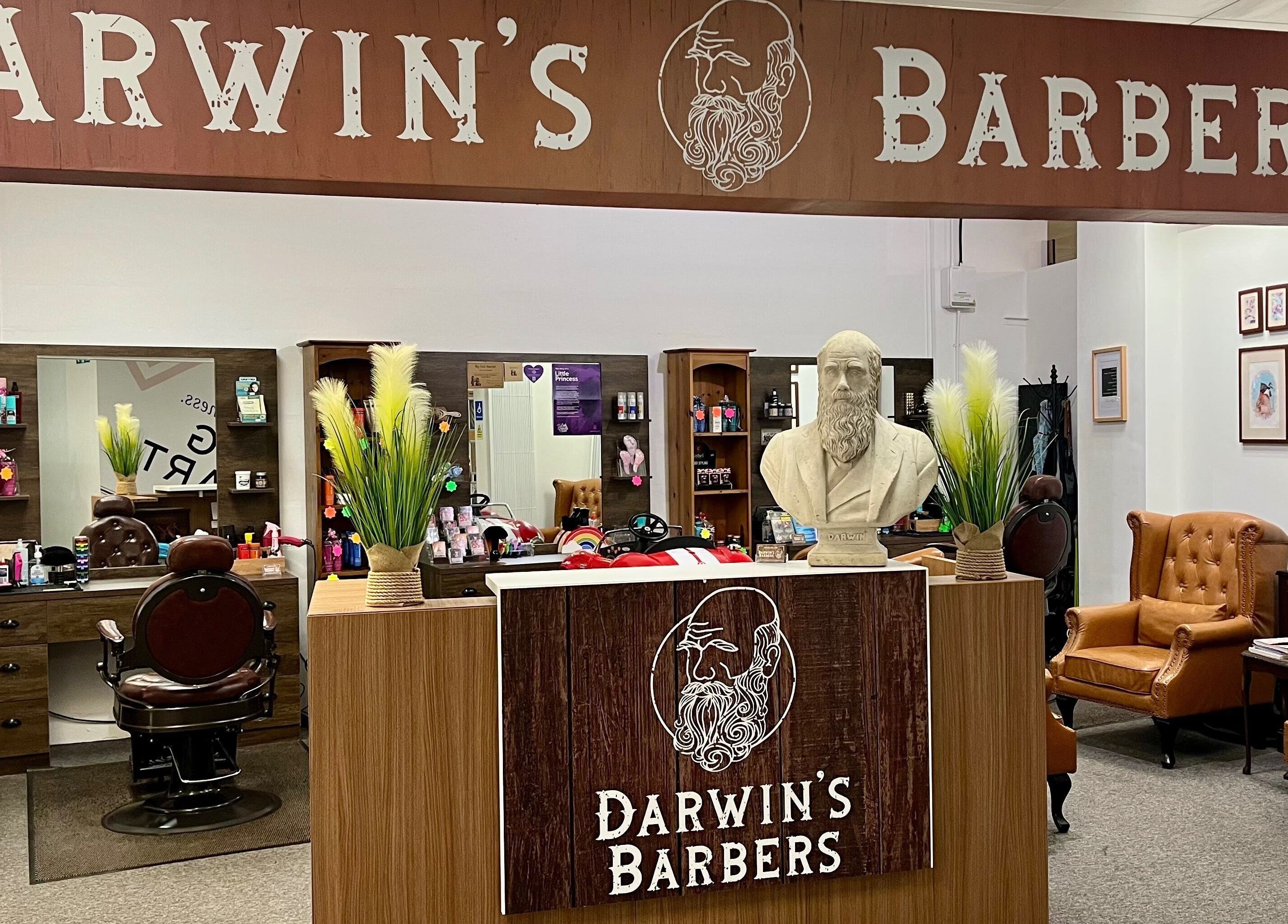 Interior of Darwin's Barbers, Shrewsbury, England. Classic chair, mirrors, and barber tools in cozy setting.