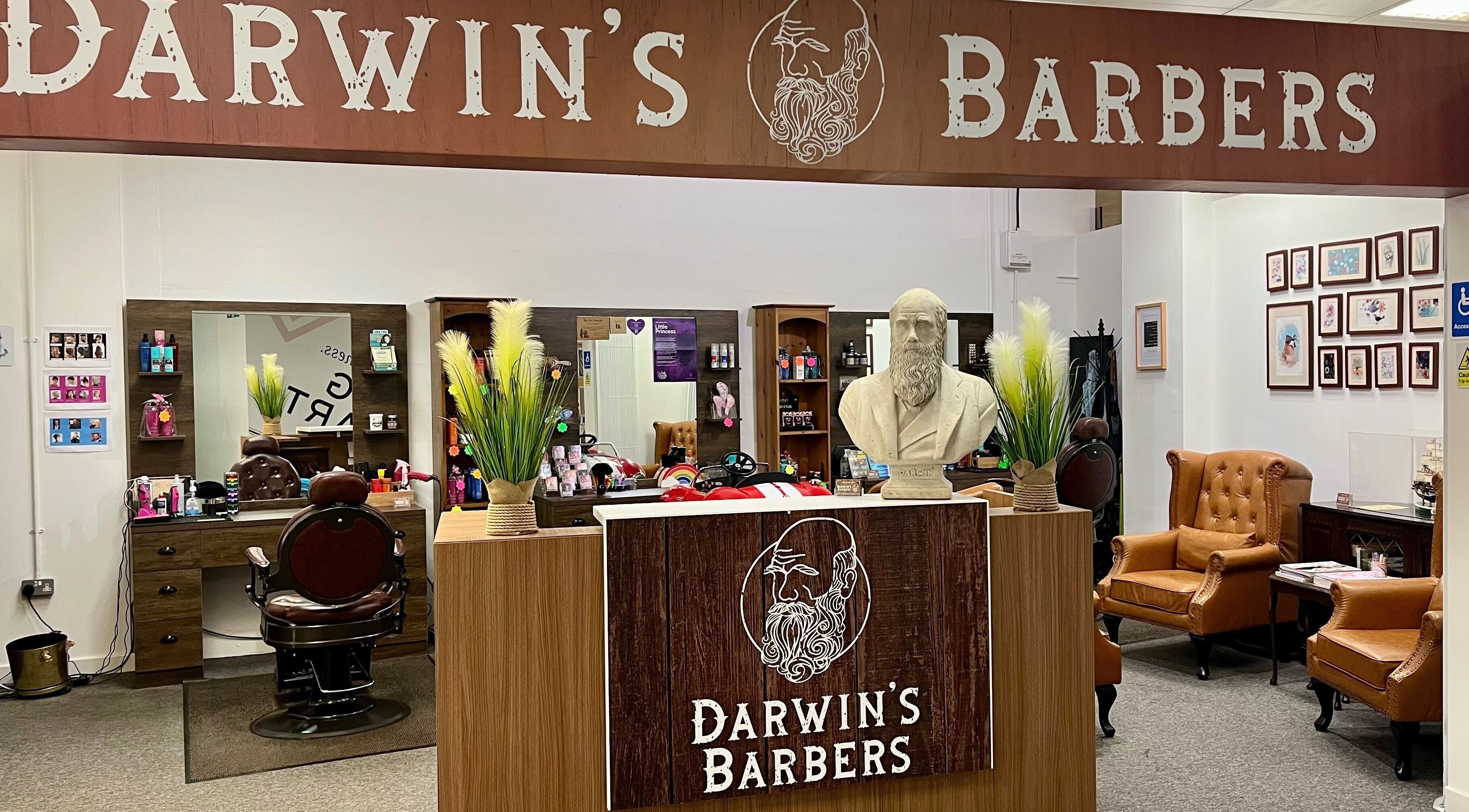 Interior of Darwin's Barbers, Shrewsbury, England. Classic chair, mirrors, and barber tools in cozy setting.