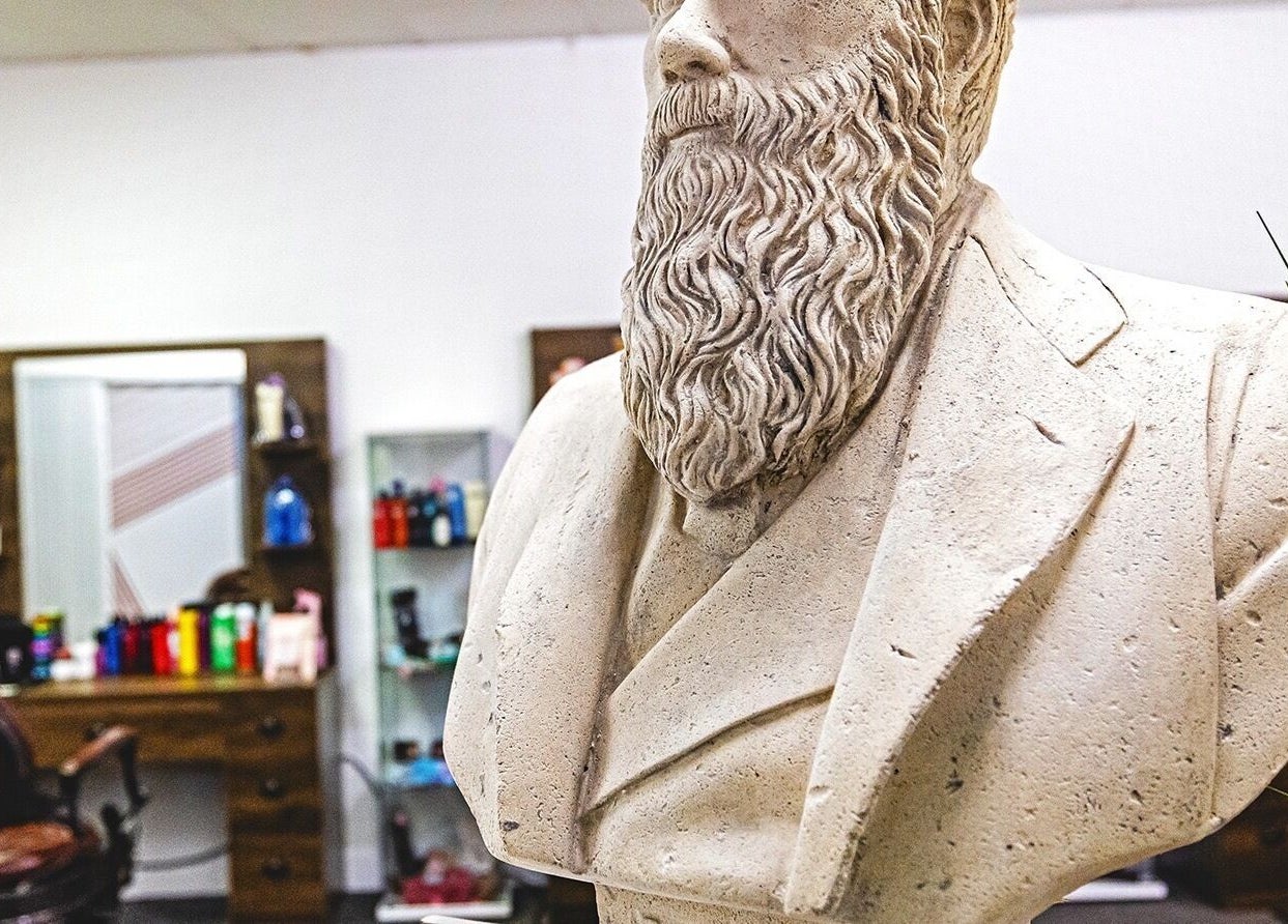 Sculpted bust at Darwin's Barbers in Shrewsbury, England, GB with salon tools in the background.