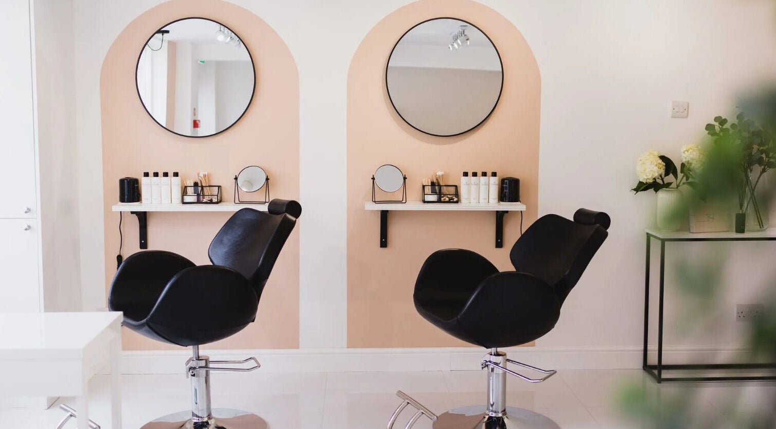 Elegant salon interior at Allure Beauty, Quorn, England, GB showcasing stylish chairs and mirrors.