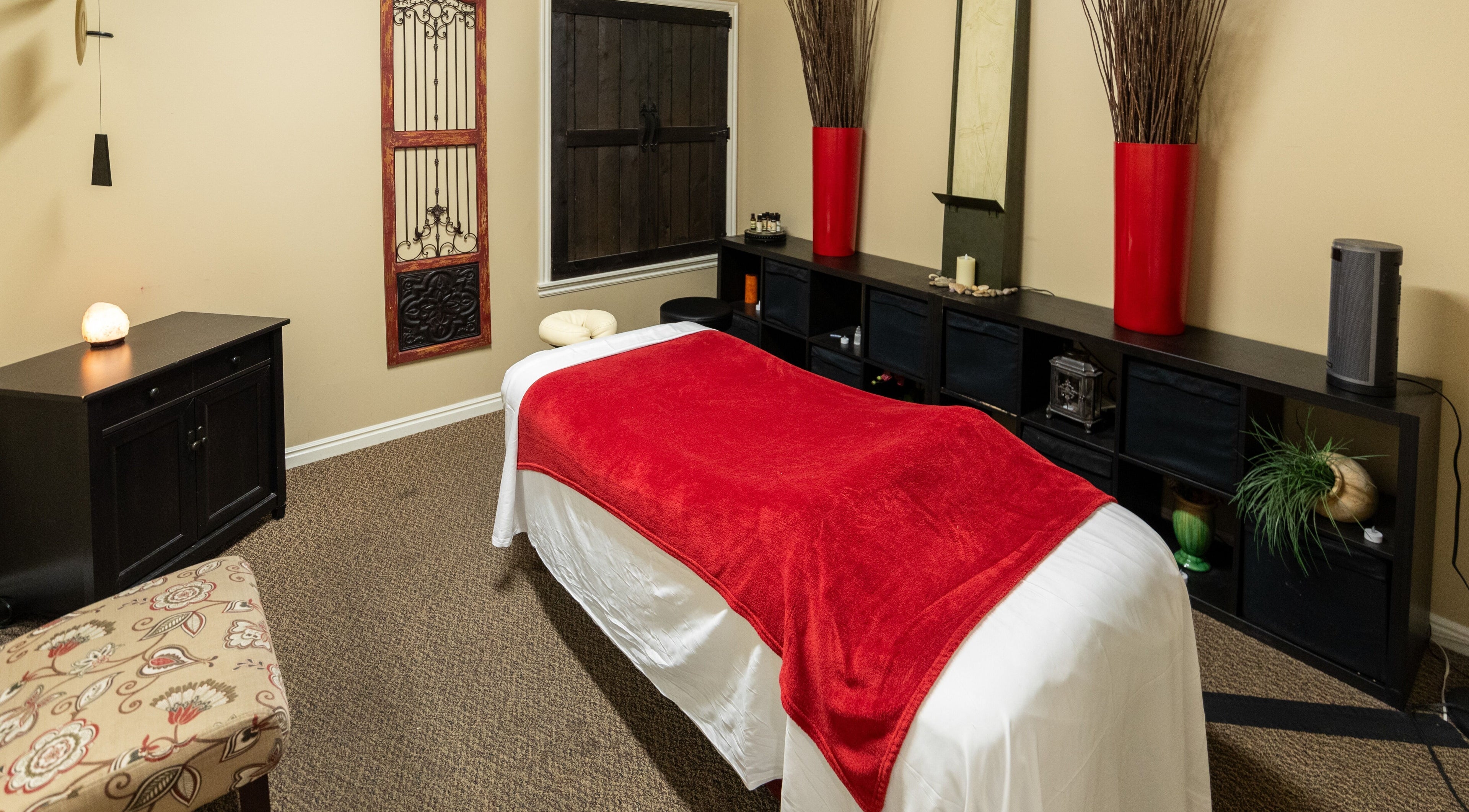 Tranquil massage room at Return To Harmony in Draper, Utah, US, featuring a cozy bed and soothing decor.