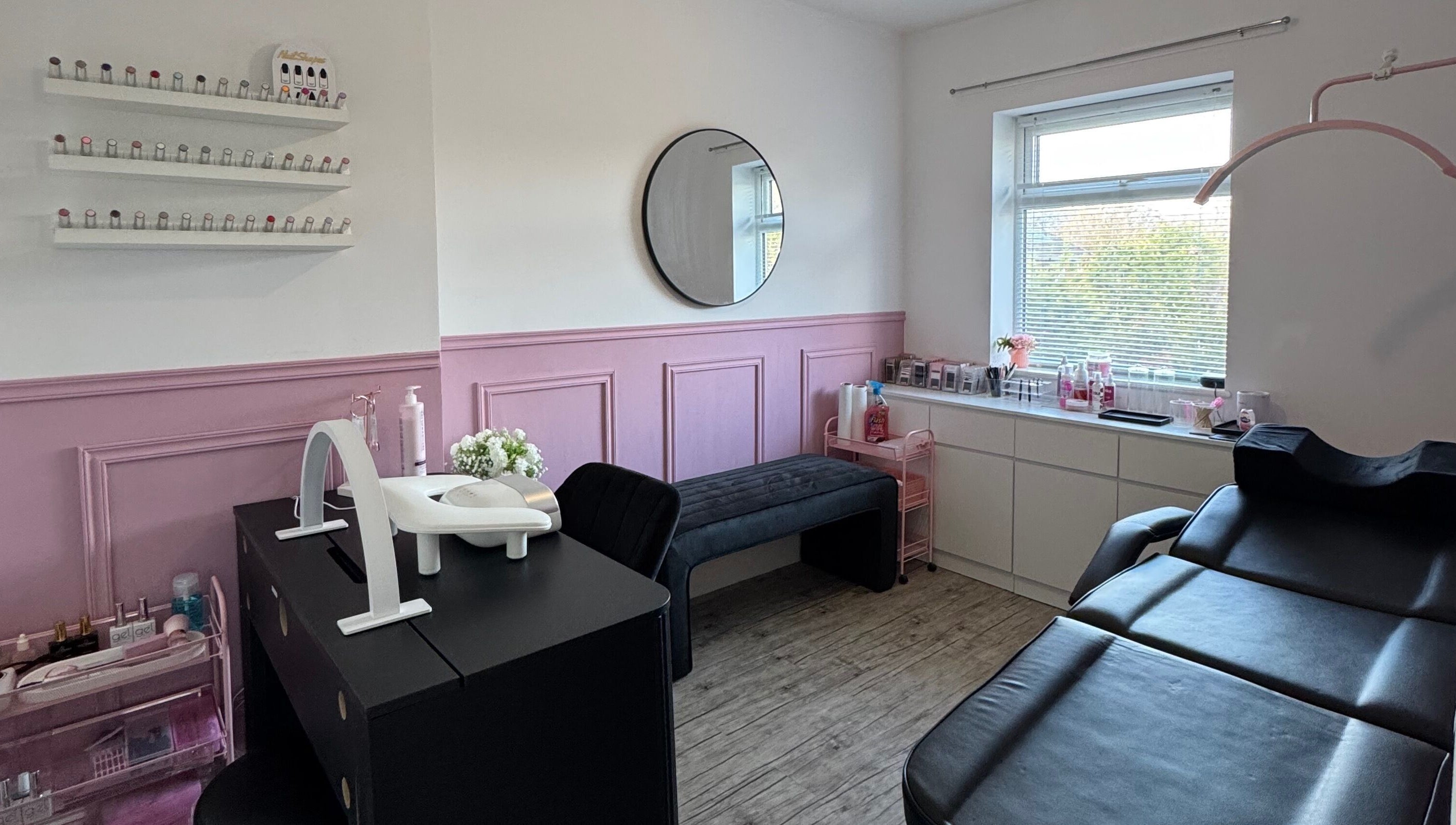 Elegant beauty room at LMA Beauty21, Gloucester, England, GB with pink accents and treatment bed.