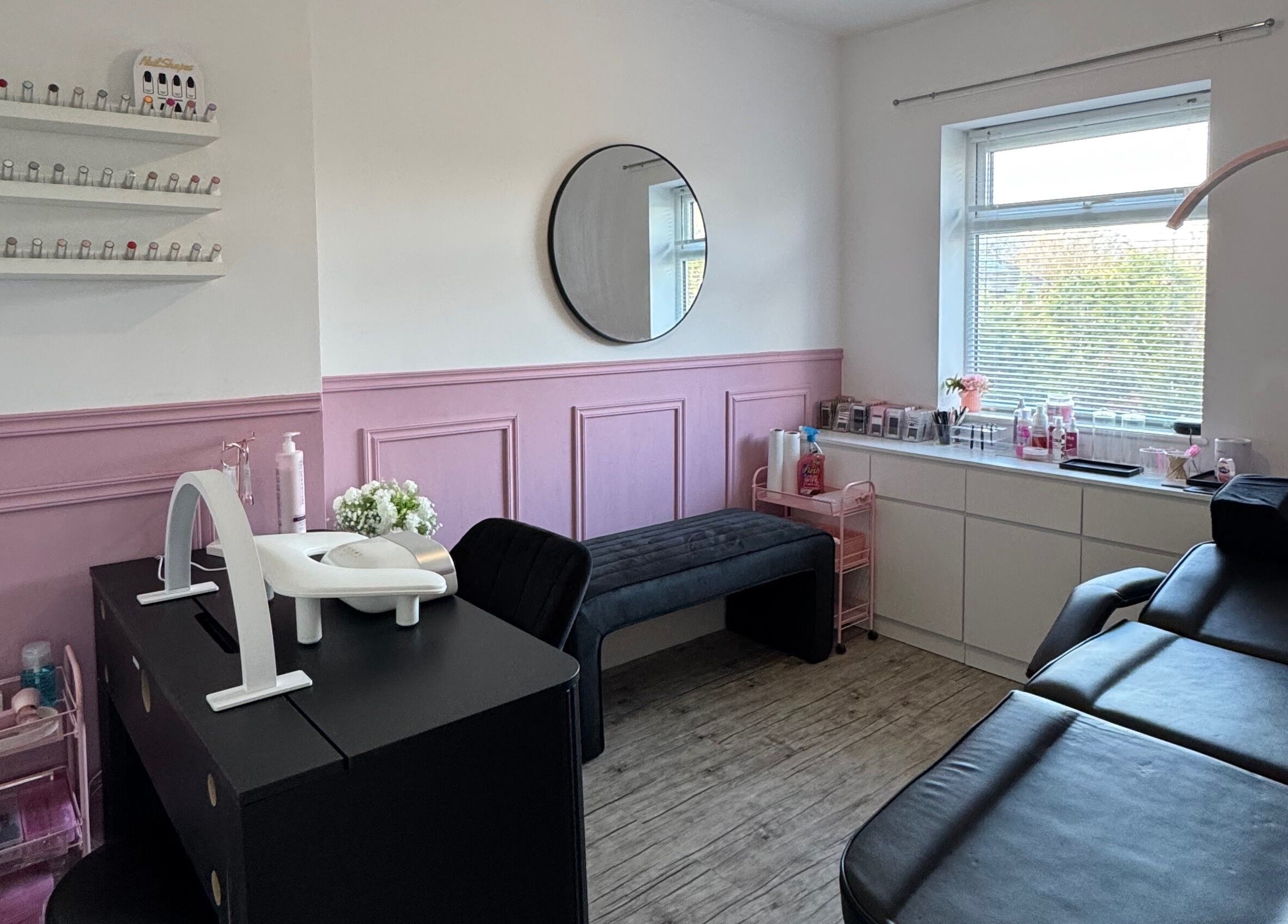 Elegant beauty room at LMA Beauty21, Gloucester, England, GB with pink accents and treatment bed.
