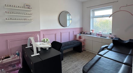 Elegant beauty room at LMA Beauty21, Gloucester, England, GB with pink accents and treatment bed.