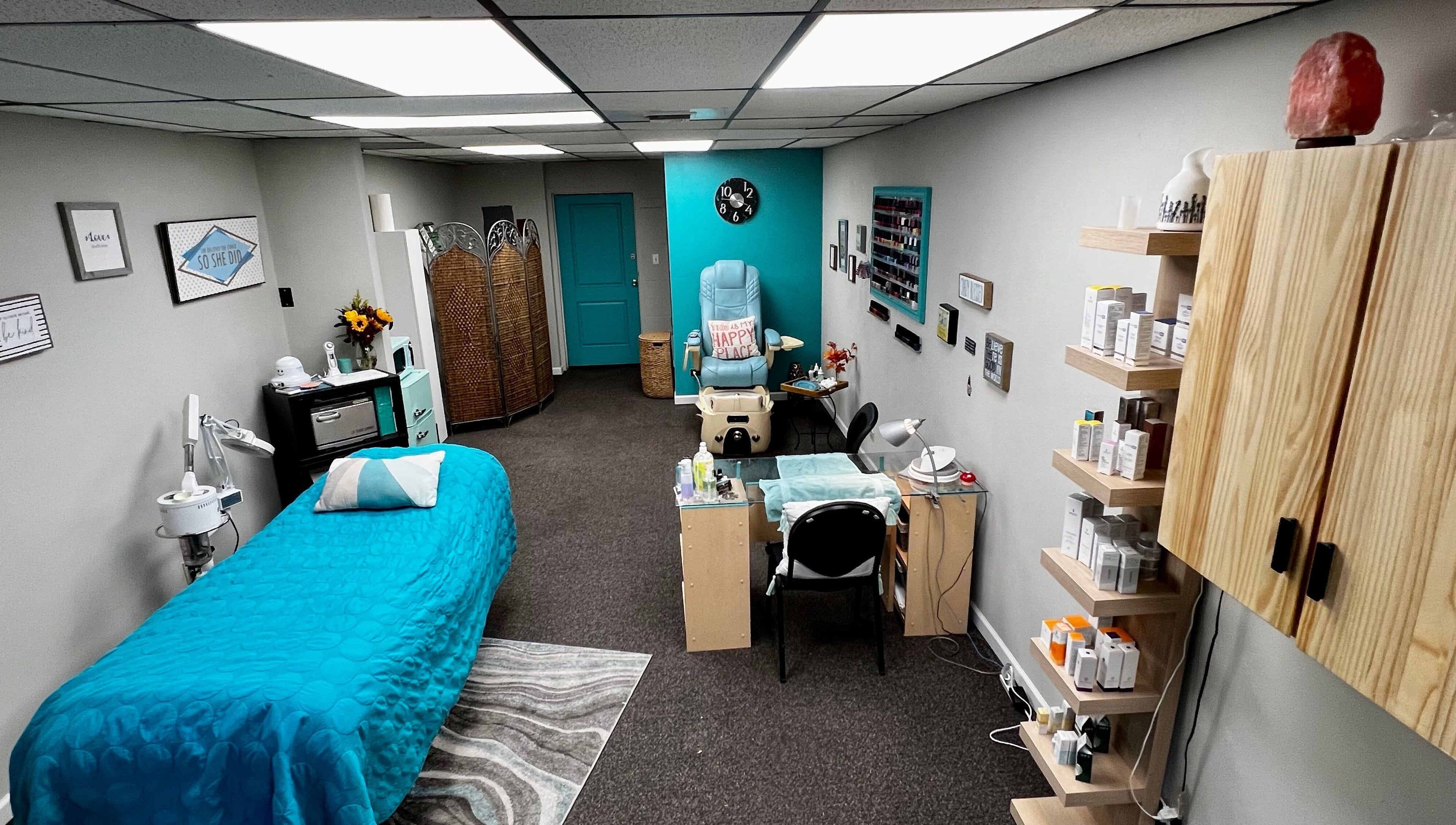Relaxing treatment room at Head to Toe Studio, Arvada, Colorado, US with massage table and beauty products.