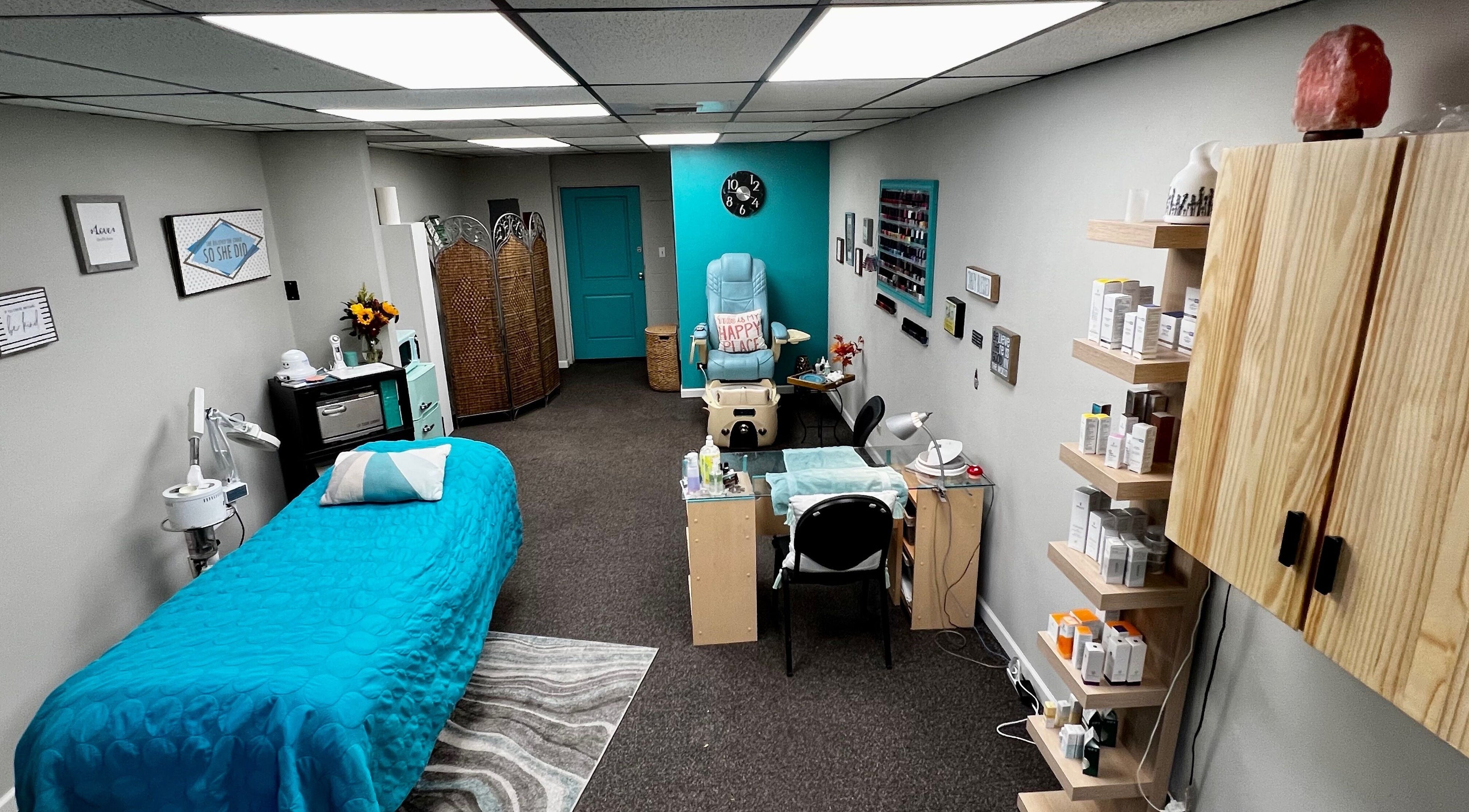 Relaxing treatment room at Head to Toe Studio, Arvada, Colorado, US with massage table and beauty products.
