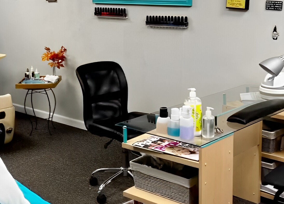 Nail station at Head to Toe Studio, Arvada, Colorado, US with chair, polish rack, and manicure tools.