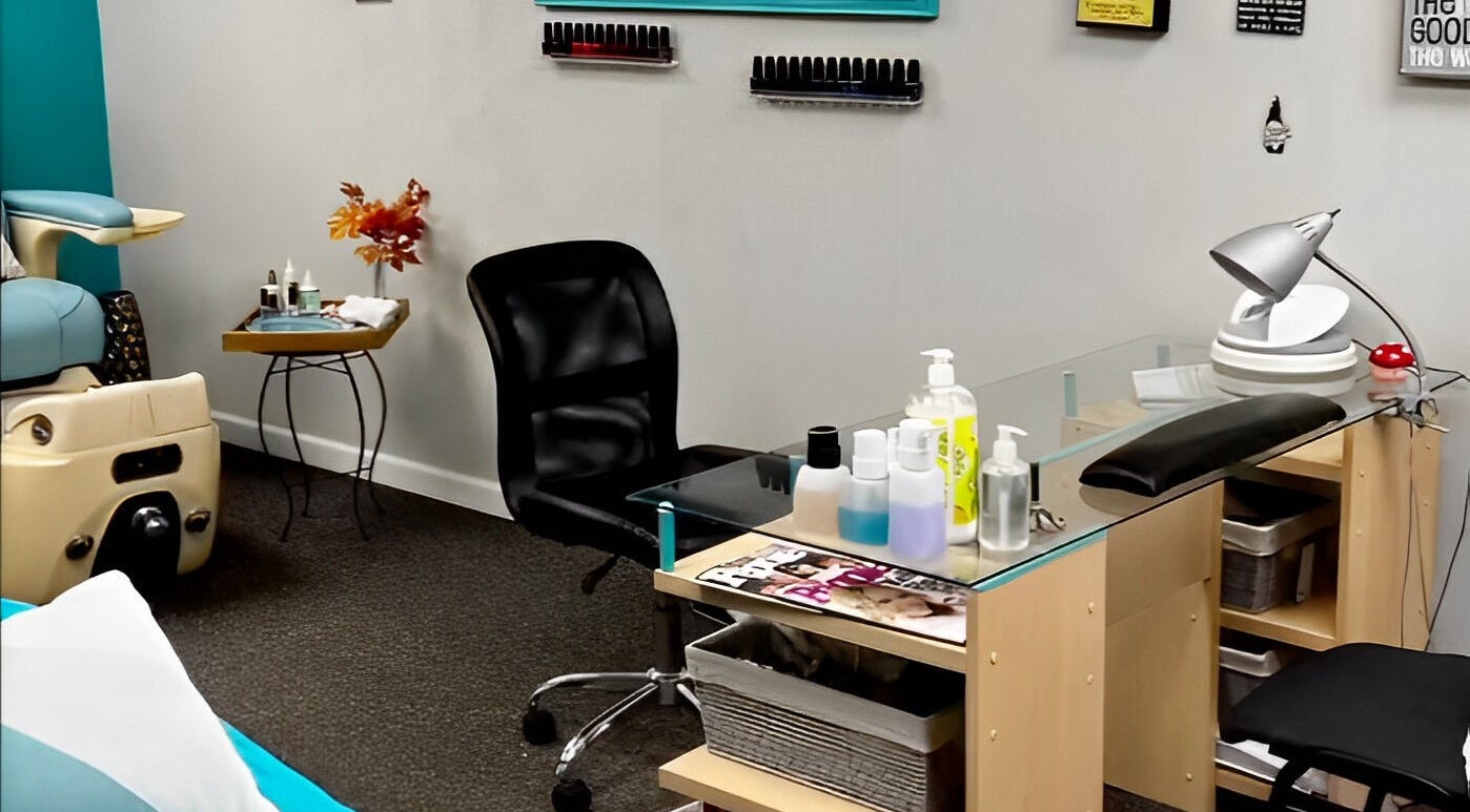 Nail station at Head to Toe Studio, Arvada, Colorado, US with chair, polish rack, and manicure tools.