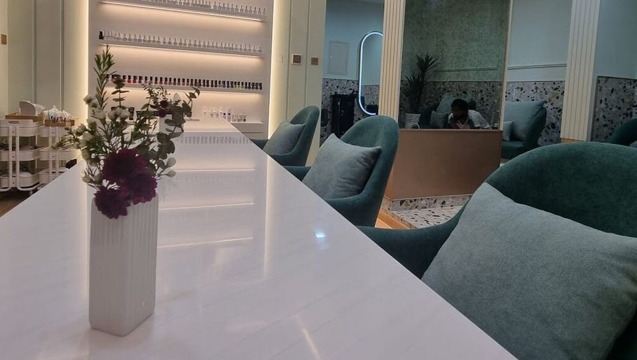 Modern decor at Polish Beauty Lounge Salon, Umm Al Quwain with plush seating and floral accents.