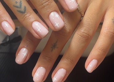 Elegant starry nail art on hands at Casa Artistry, Campsie, New South Wales, AU.